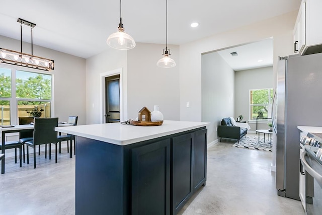 2122 Deaton St, San Angelo, TX 76903 - kitchen featuring appliances with stainless steel finishes, concrete floors, light countertops, white cabinets, and recessed lighting