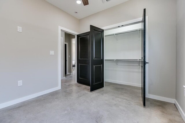 2122 Deaton St, San Angelo, TX 76903 - unfurnished bedroom with finished concrete floors, baseboards, a closet, and a ceiling fan