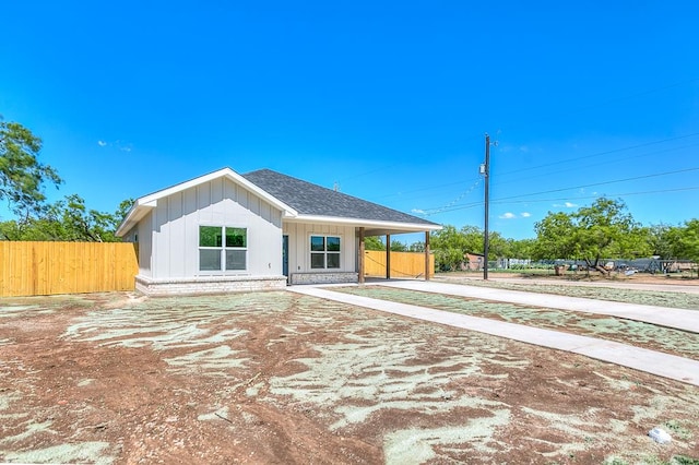 2122 Deaton St, San Angelo, TX 76903 - view of front of property with fence, concrete driveway, board and batten siding, and roof with shingles