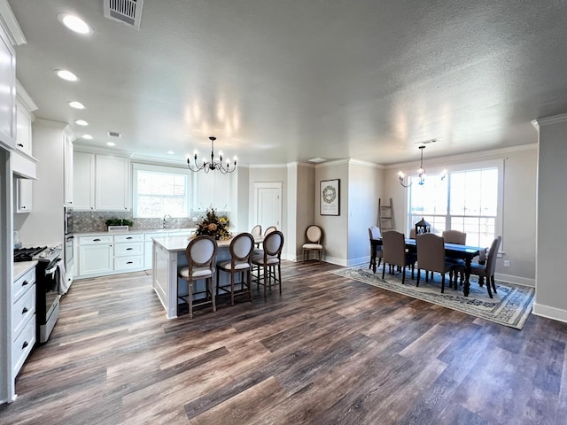 1962 Beaty Rd, San Angelo, TX 76904 - kitchen with a chandelier, stainless steel gas range, baseboards, ornamental molding, and recessed lighting