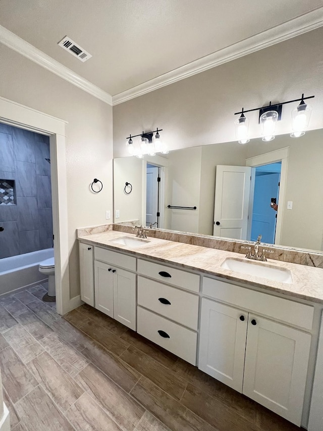 1962 Beaty Rd, San Angelo, TX 76904 - full bath featuring crown molding, wood finished floors, double vanity, and toilet