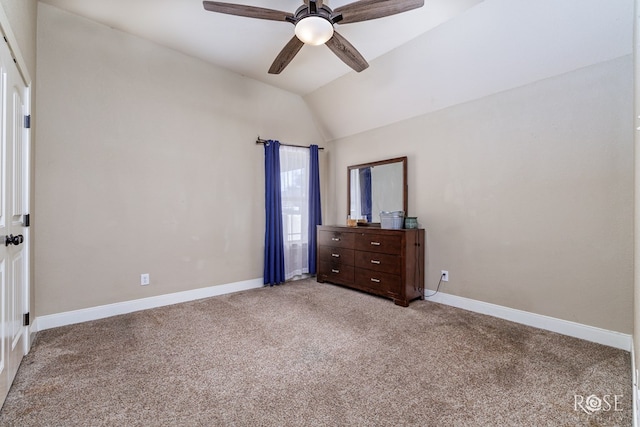 unfurnished bedroom featuring lofted ceiling, light colored carpet, baseboards, and ceiling fan