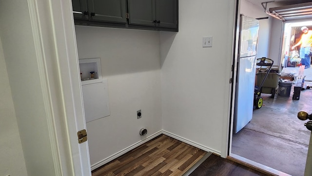 laundry room featuring hookup for a washing machine, dark hardwood / wood-style flooring, electric dryer hookup, and cabinets