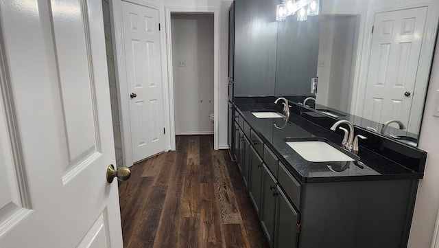 bathroom with hardwood / wood-style flooring, vanity, and toilet