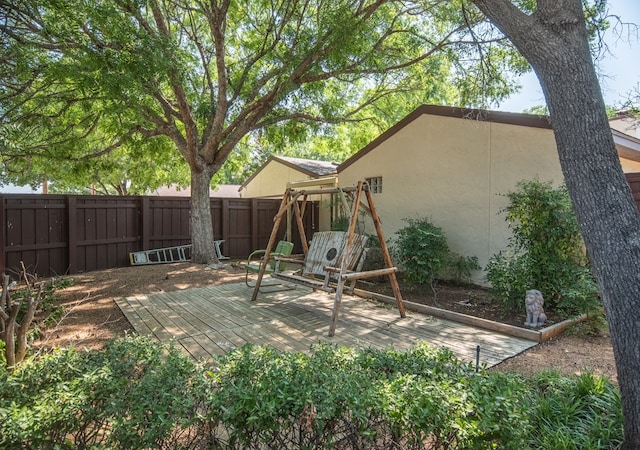 exterior space featuring a wooden deck and a playground