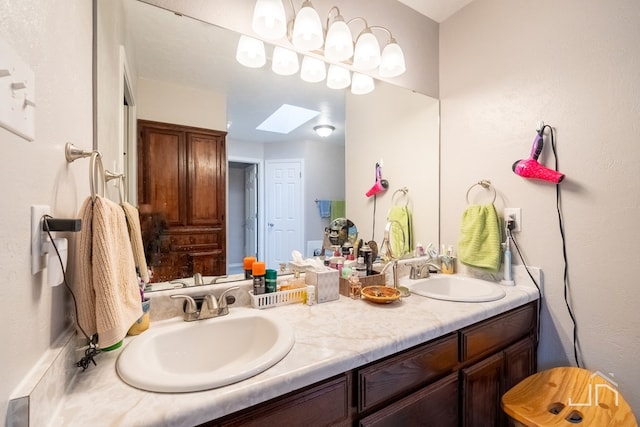 bathroom with vanity and a skylight