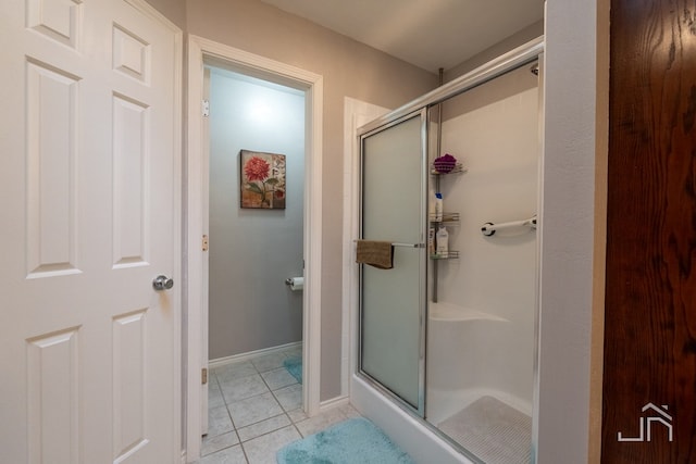 bathroom with tile patterned floors and a shower with shower door