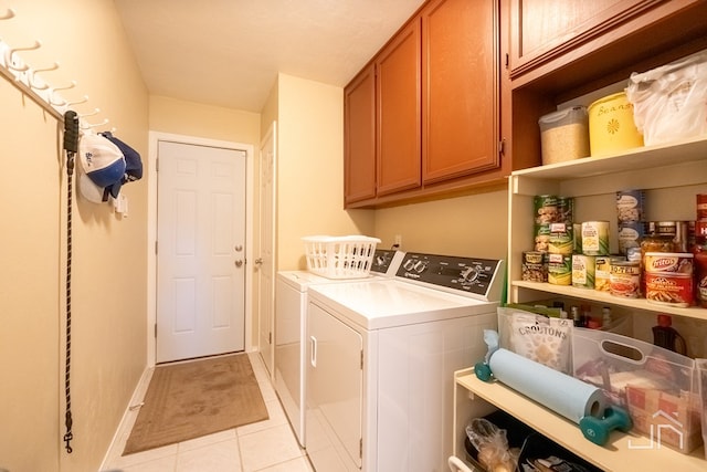 laundry area featuring independent washer and dryer, cabinets, and light tile patterned floors