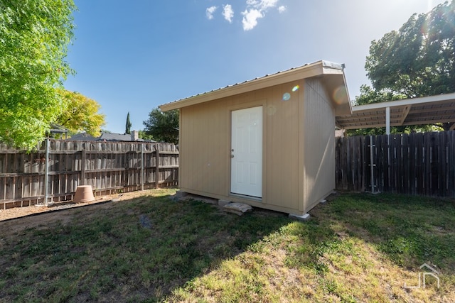 view of outbuilding with a yard