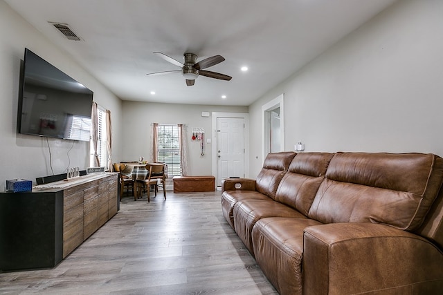 living room featuring ceiling fan and light wood-type flooring