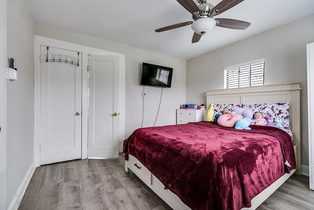 bedroom featuring hardwood / wood-style flooring and ceiling fan