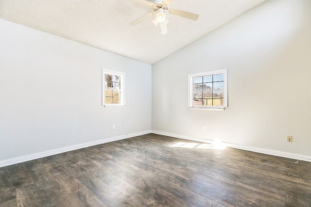 empty room featuring dark wood-type flooring, ceiling fan, vaulted ceiling, and a textured ceiling