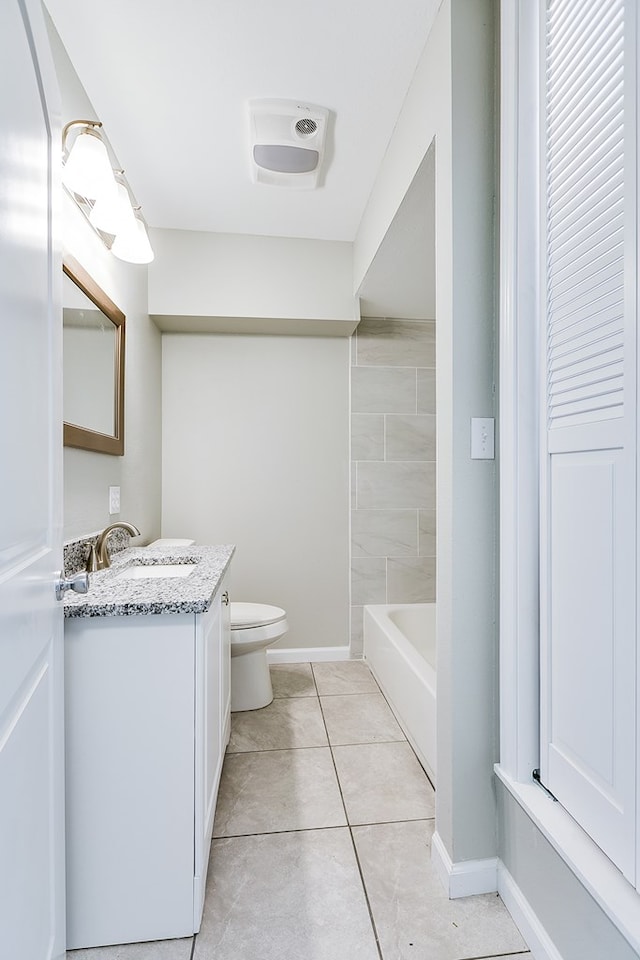 bathroom with vanity, tile patterned flooring, and toilet