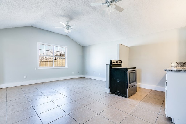 interior space featuring lofted ceiling, stainless steel electric range, light tile patterned floors, a textured ceiling, and ceiling fan