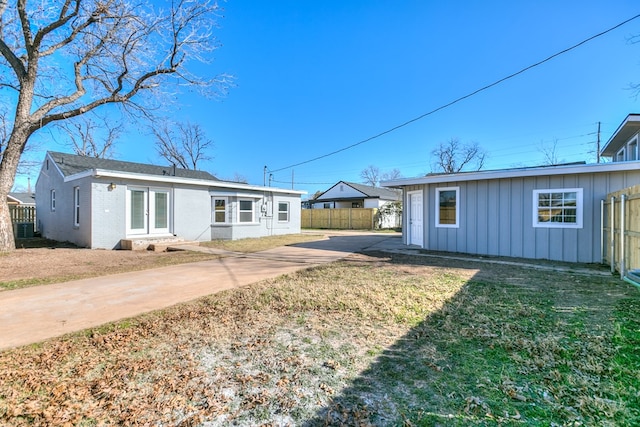 back of property featuring a yard