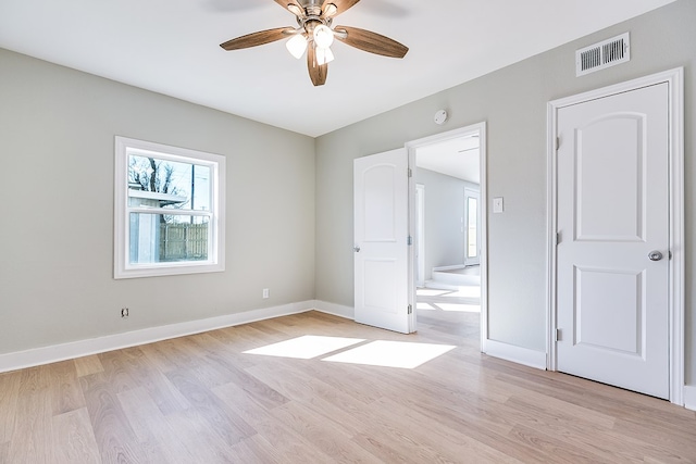 unfurnished room with ceiling fan and light wood-type flooring