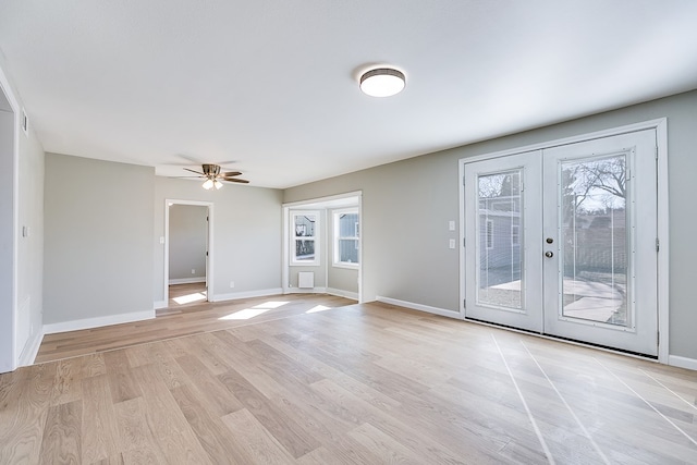 spare room featuring french doors, ceiling fan, and light hardwood / wood-style flooring