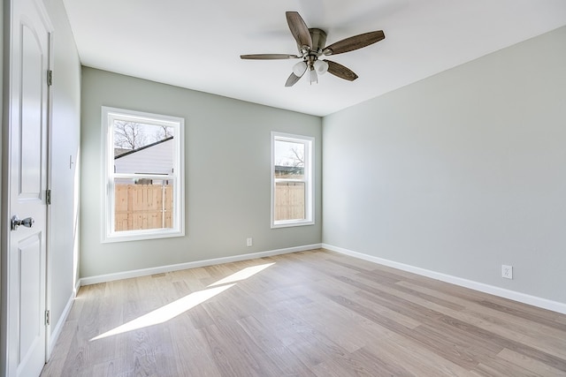 empty room with ceiling fan and light wood-type flooring