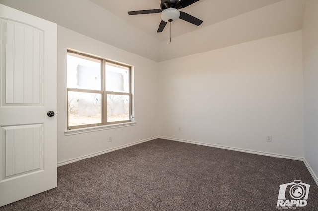 unfurnished room featuring baseboards, dark carpet, and ceiling fan