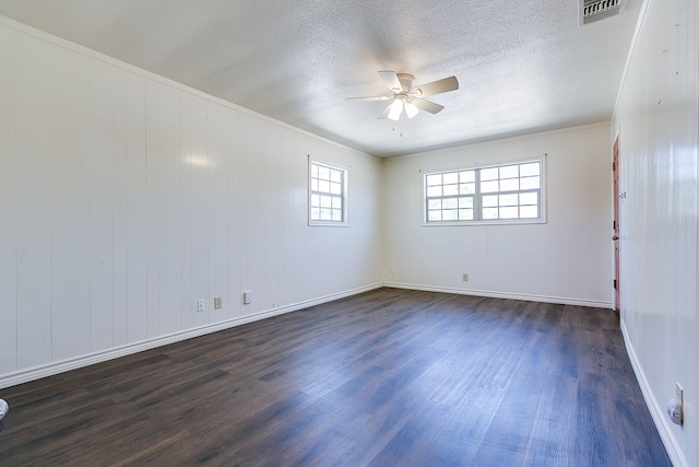2113 S Hill St, San Angelo, TX 76903 - empty room featuring ceiling fan, dark wood-style flooring, a textured ceiling, baseboards, and crown molding
