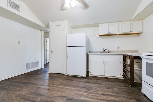 2113 S Hill St, San Angelo, TX 76903 - kitchen with white appliances, vaulted ceiling, a sink, light countertops, and white cabinetry