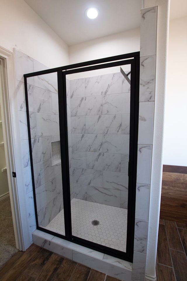 9614 Bighorn Trl, San Angelo, TX 76901 - bathroom featuring a stall shower, wood finished floors, and recessed lighting