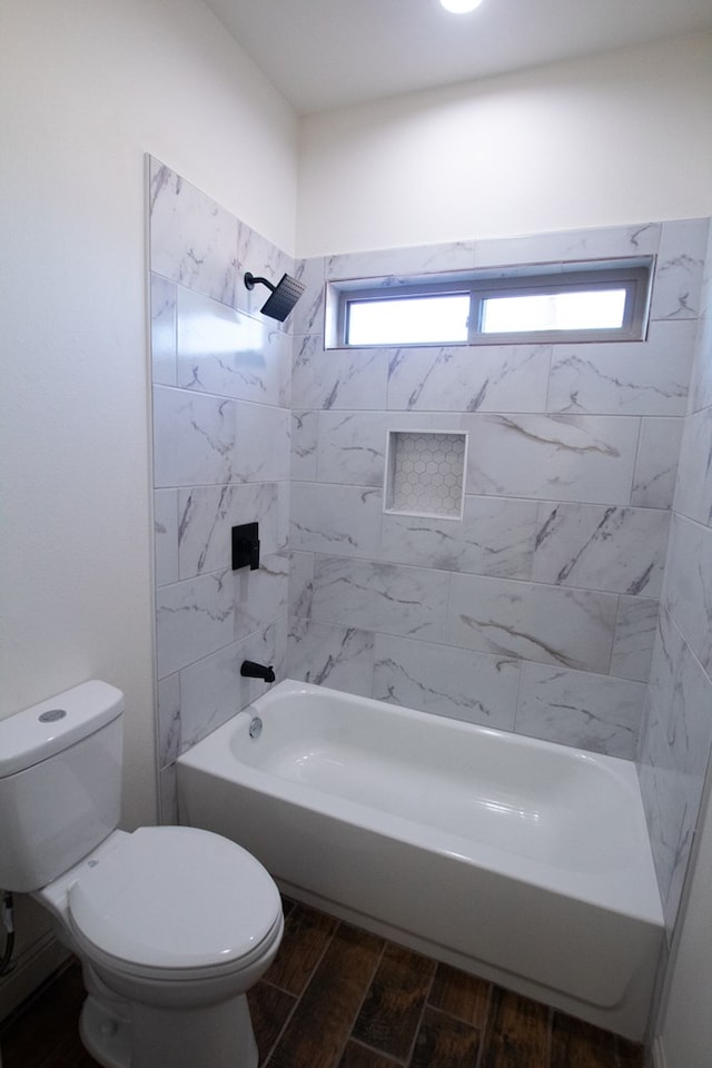 9614 Bighorn Trl, San Angelo, TX 76901 - bathroom featuring toilet, wood tiled floors, and bathing tub / shower combination