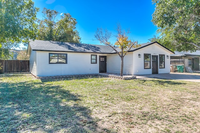 single story home with a front yard and a patio