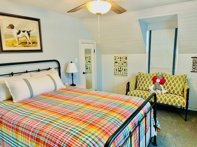 bedroom featuring carpet floors, ceiling fan, and lofted ceiling