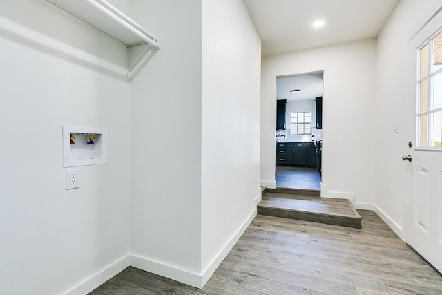 laundry room with hardwood / wood-style flooring and washer hookup