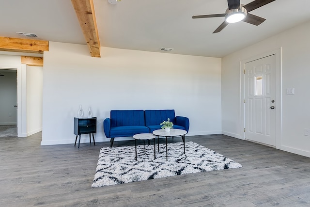 living area with beamed ceiling, ceiling fan, and hardwood / wood-style floors