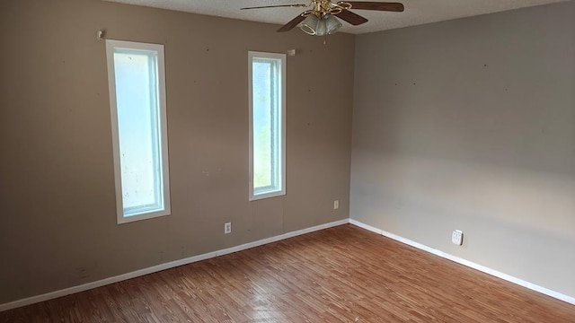 spare room with a textured ceiling, ceiling fan, and light wood-type flooring