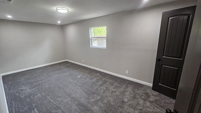 2514 S Hill St, San Angelo, TX 76903 - spare room with baseboards, recessed lighting, dark carpet, and visible vents