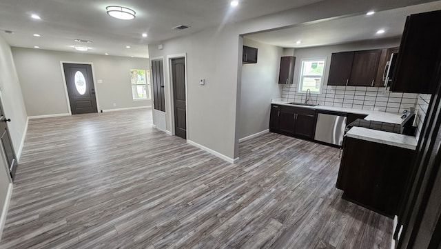 2514 S Hill St, San Angelo, TX 76903 - kitchen featuring a sink, decorative backsplash, light countertops, dishwasher, and open floor plan