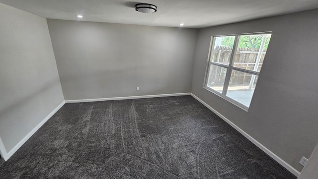 2514 S Hill St, San Angelo, TX 76903 - unfurnished room with baseboards, dark colored carpet, and recessed lighting