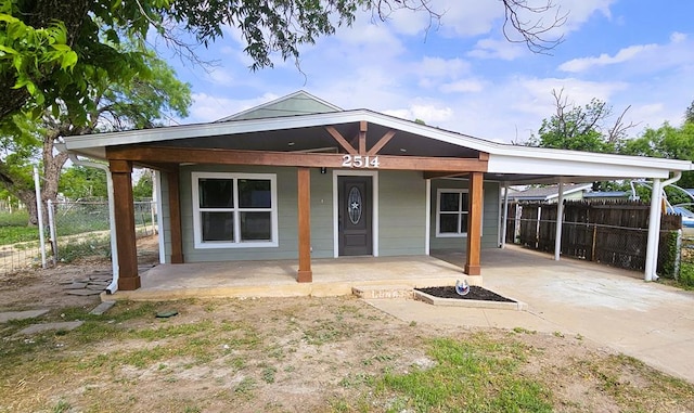 2514 S Hill St, San Angelo, TX 76903 - view of front of property with covered porch, fence, a carport, and driveway