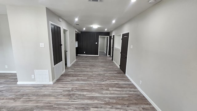2514 S Hill St, San Angelo, TX 76903 - hall with baseboards, visible vents, and wood finished floors