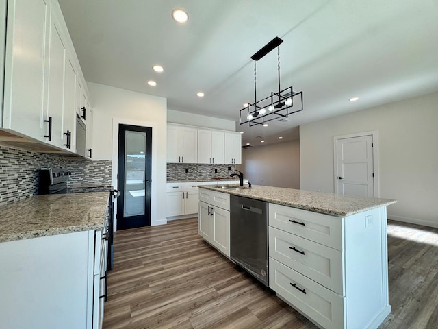 kitchen with a sink, white cabinets, wood finished floors, and appliances with stainless steel finishes