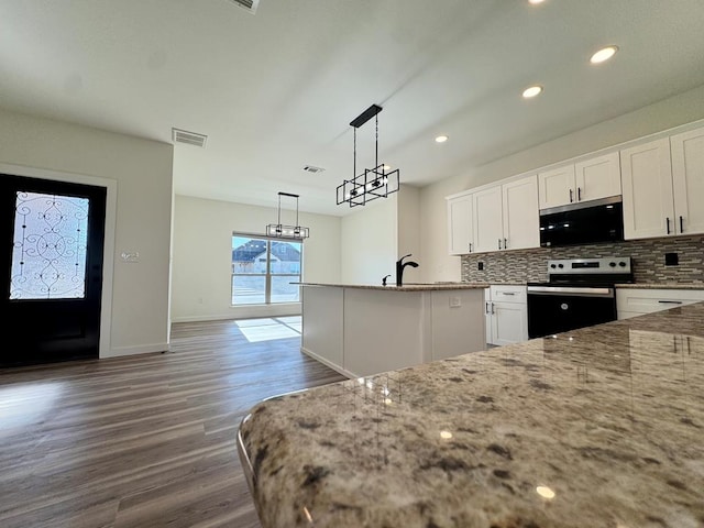 kitchen with decorative backsplash, dark wood-style flooring, white cabinets, light stone countertops, and electric range