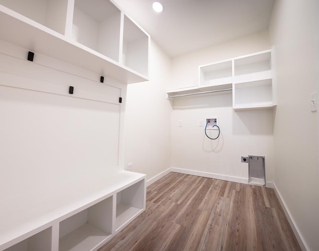 interior space with washer hookup, baseboards, wood finished floors, laundry area, and electric dryer hookup