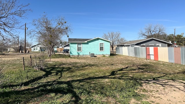 back of property featuring a lawn