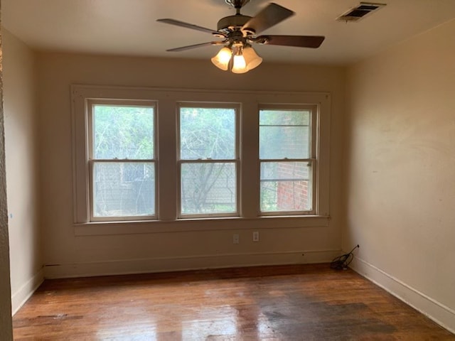 606 Pulliam St, San Angelo, TX 76903 - empty room featuring plenty of natural light, baseboards, and wood finished floors