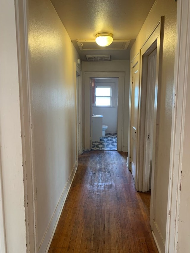 606 Pulliam St, San Angelo, TX 76903 - corridor featuring dark wood-type flooring and attic access