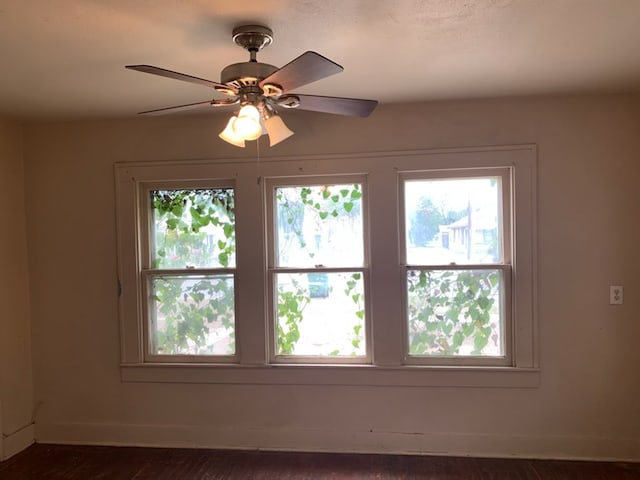 606 Pulliam St, San Angelo, TX 76903 - empty room featuring baseboards, ceiling fan, and dark wood-style floors