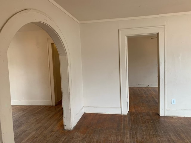 606 Pulliam St, San Angelo, TX 76903 - empty room featuring wood-type flooring, arched walkways, baseboards, and ornamental molding