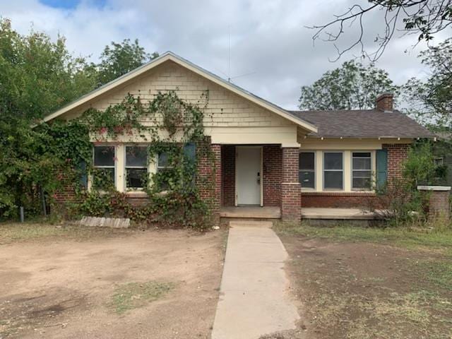 606 Pulliam St, San Angelo, TX 76903 - bungalow-style home with brick siding and a chimney