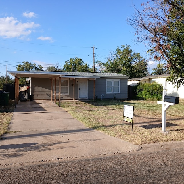 view of front of property featuring a carport and a front lawn