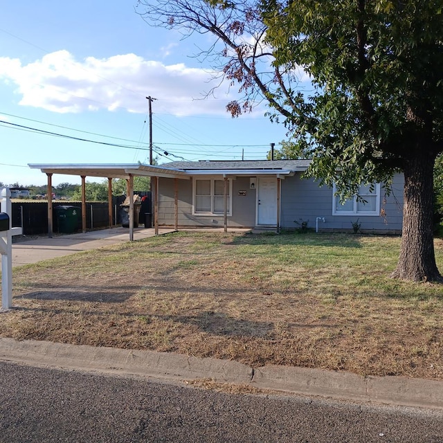 view of front of home with a carport and a front yard