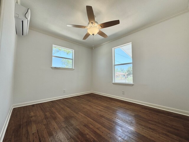 spare room featuring dark wood-type flooring, ceiling fan, and ornamental molding