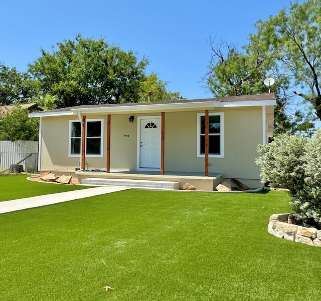 ranch-style house featuring a porch and a front yard